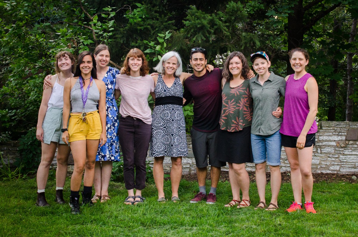 Nine members of the Grossman Lab stand together and smile for the camera